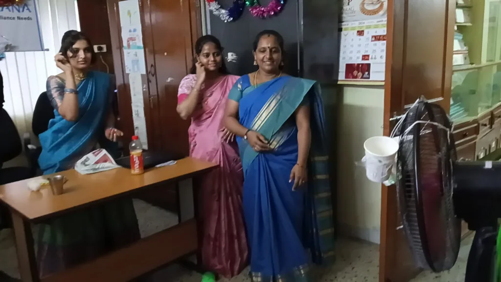 employees-gathered-around-office-table-samarthana