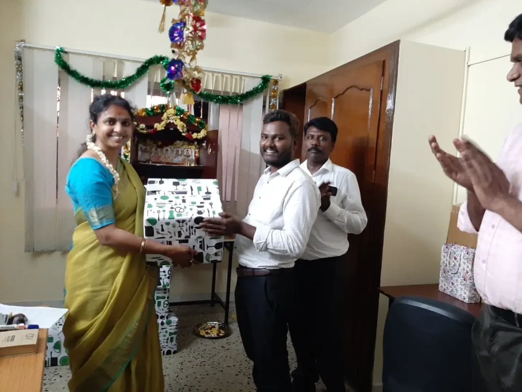 team-presenting-gift-during-office-visit-samarthana