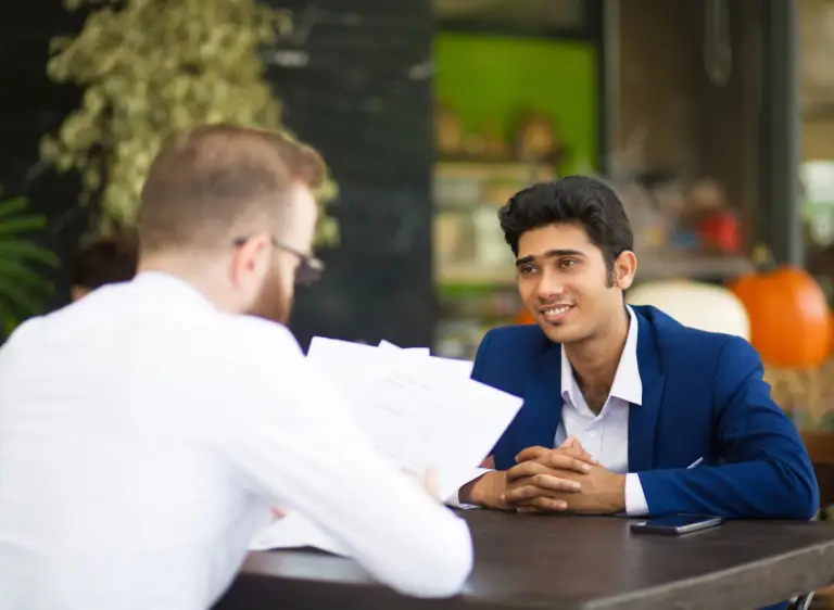 business-professionals-discussing-documents-at-meeting-samarthana-image