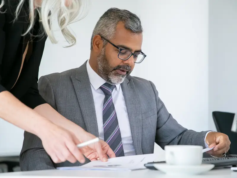 businessman-reviewing-official-documents-at-desk-samarthana-image