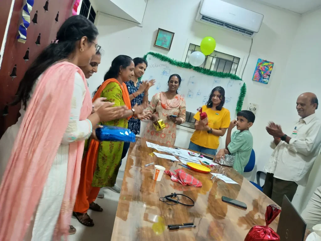 staff-members-gathered-around-table-samarthana