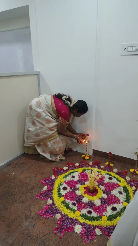 woman-arranging-flower-rangoli-samarthana