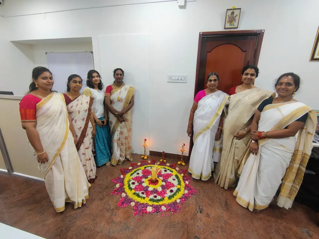 staff-members-around-flower-pookalam-samarthana