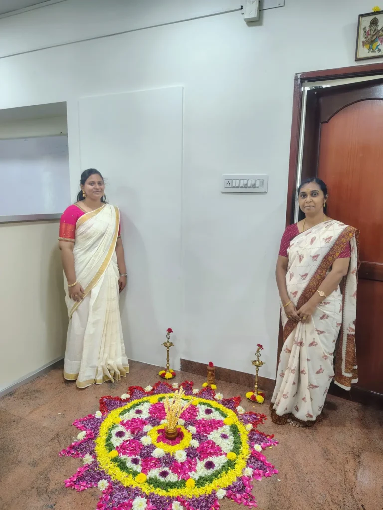 women-colleagues-preparing-flower-rangoli-samarthana